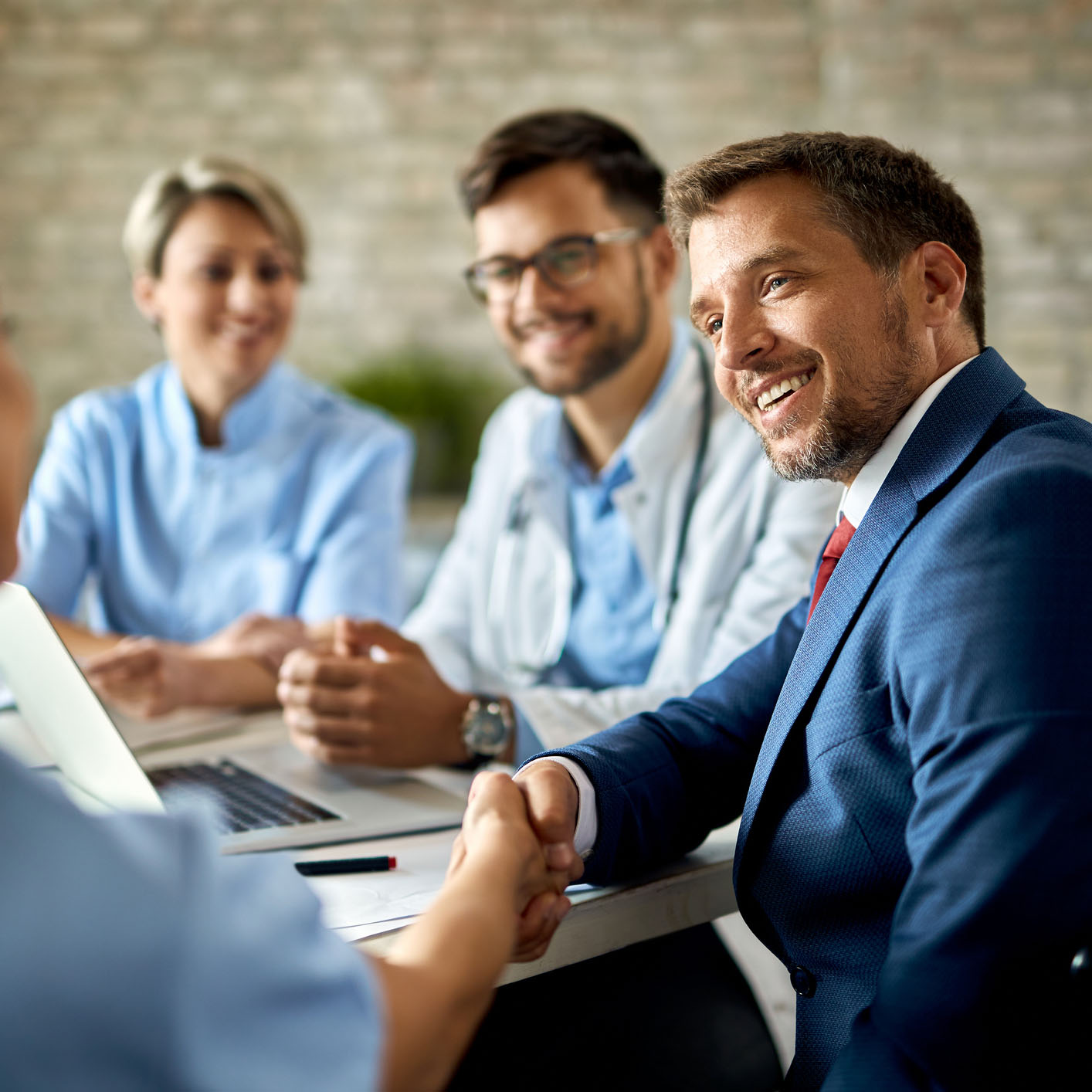 business man shaking hands with doctors