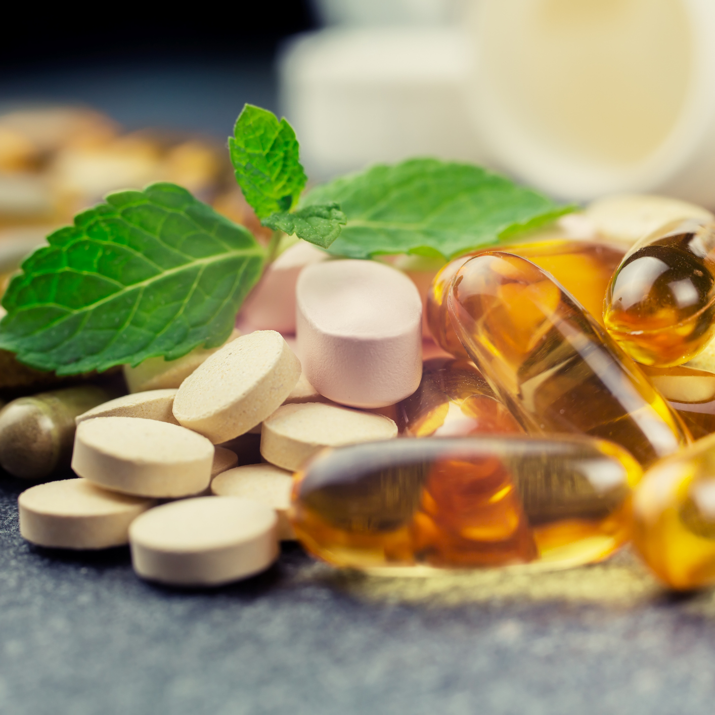 nutritional supplements and leaves on table