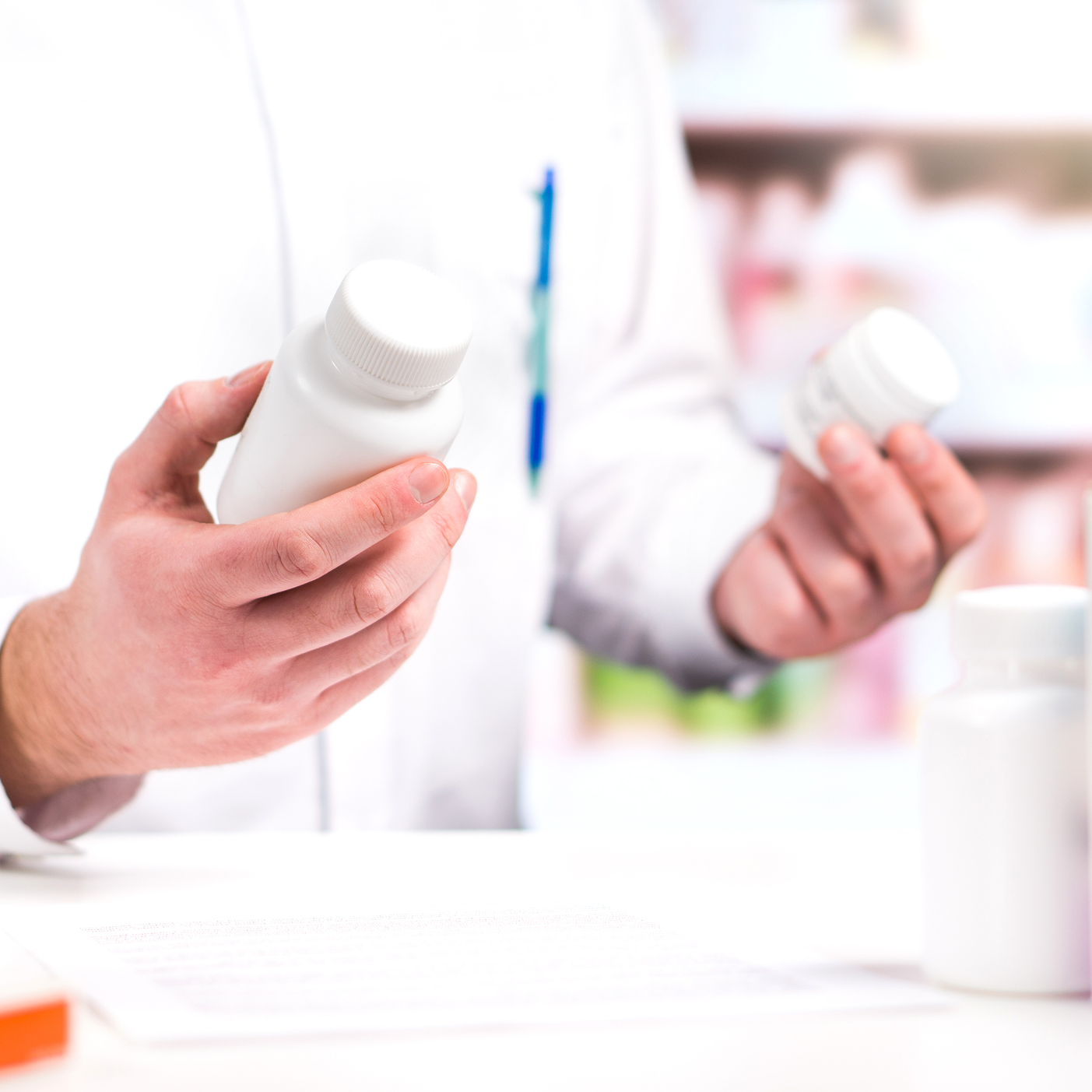 pharmacist hoding pill bottles